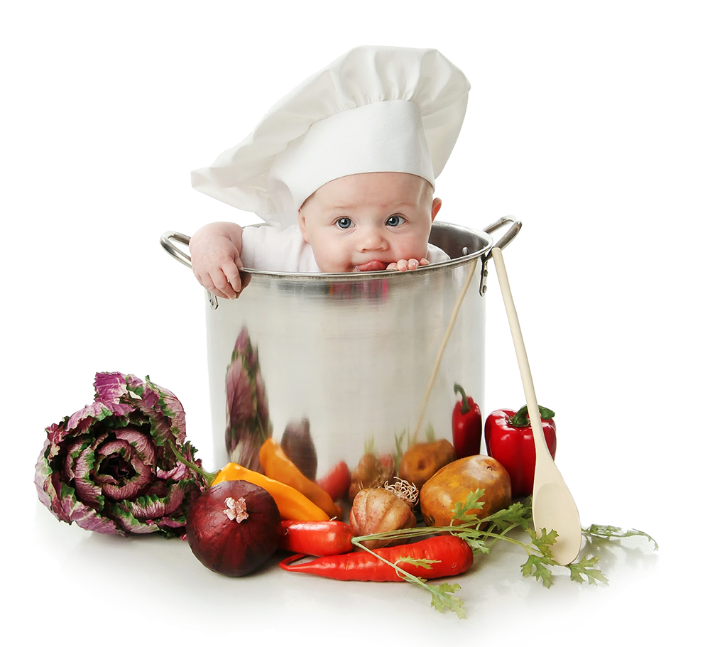 Baby chef surrounded by vegetables