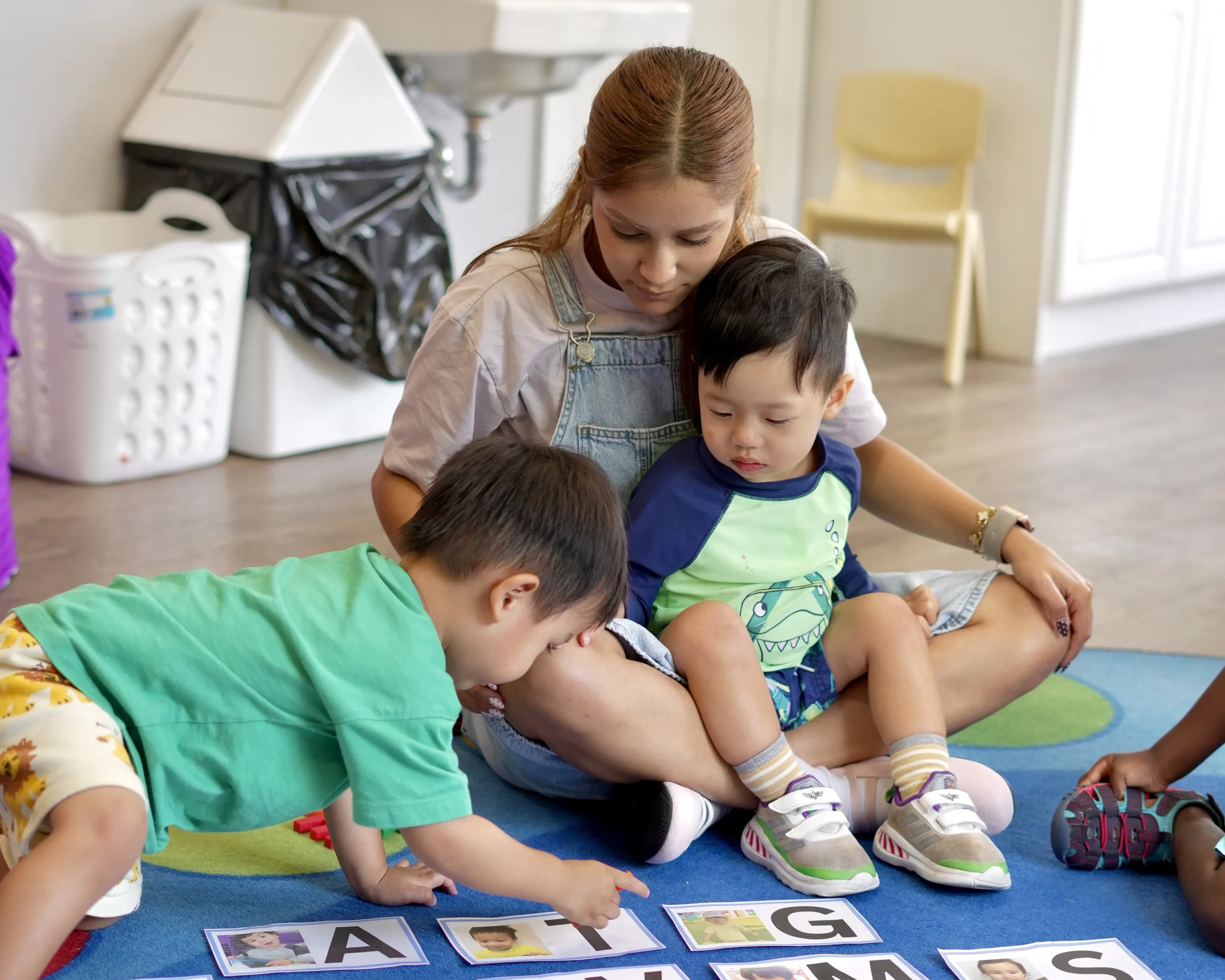 Staff and children learning on the carpet