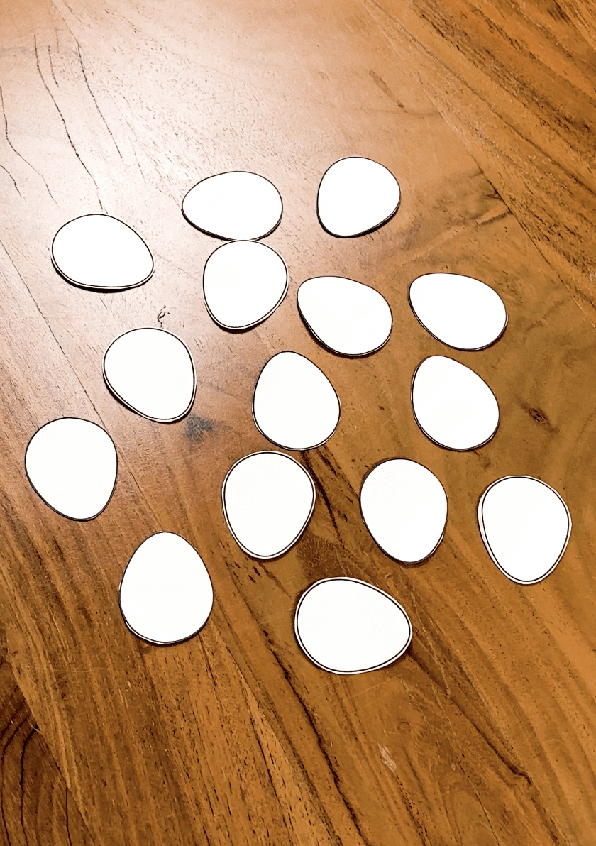 Bunch of cut out paper eggs laid out