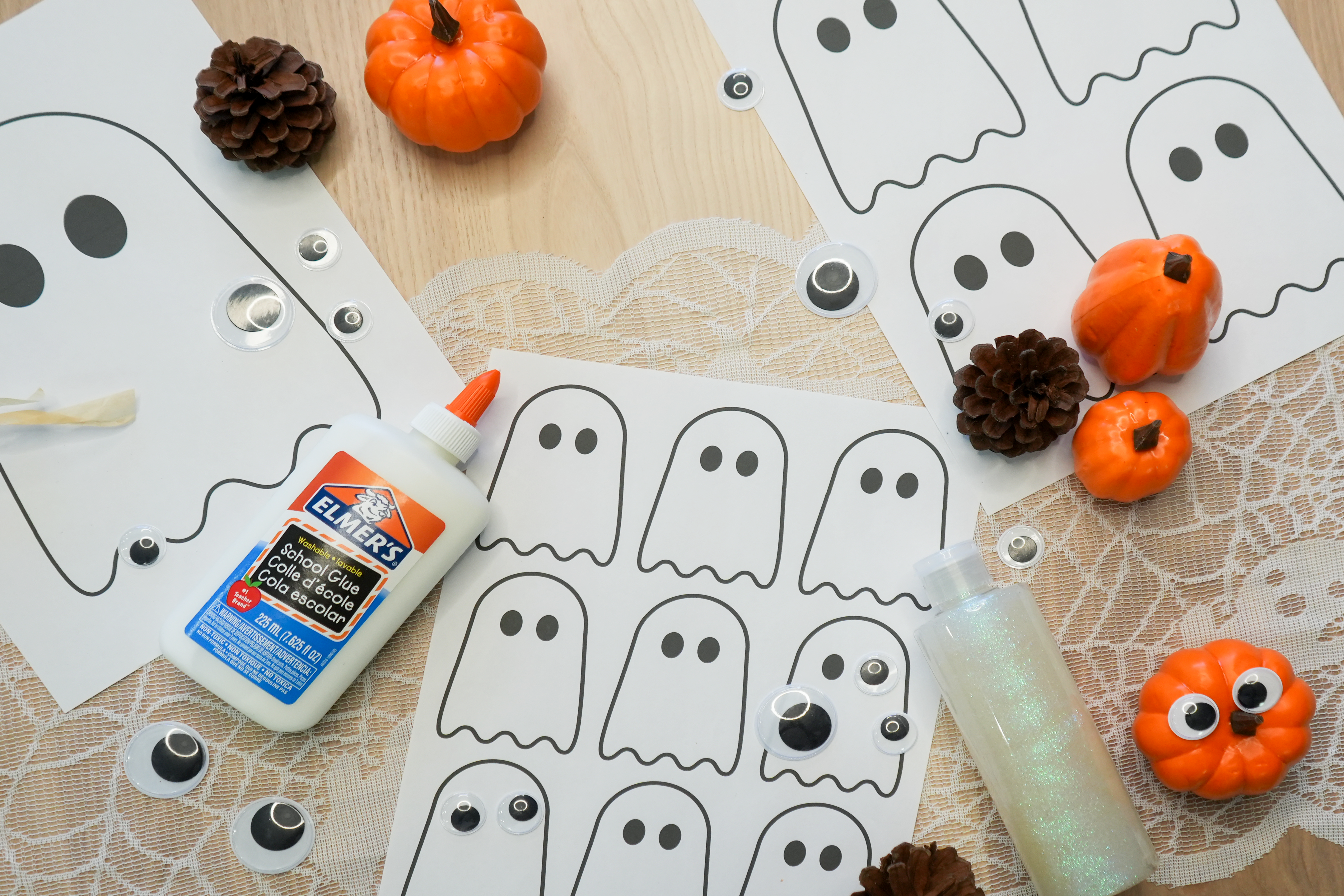 DIY spooky Craft for halloween. materials and imagery of ghosts, pumpkins, goggly eyes, an fall theme